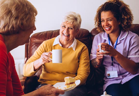 femal caregiver with two senior women