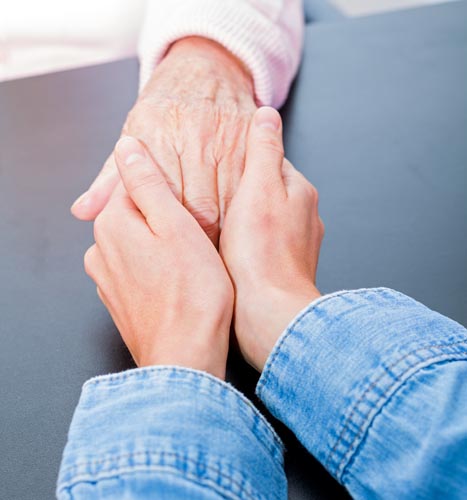 parkinsons disease caregiver holding hands