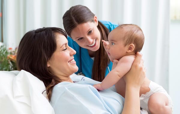 caregiver with mom and baby